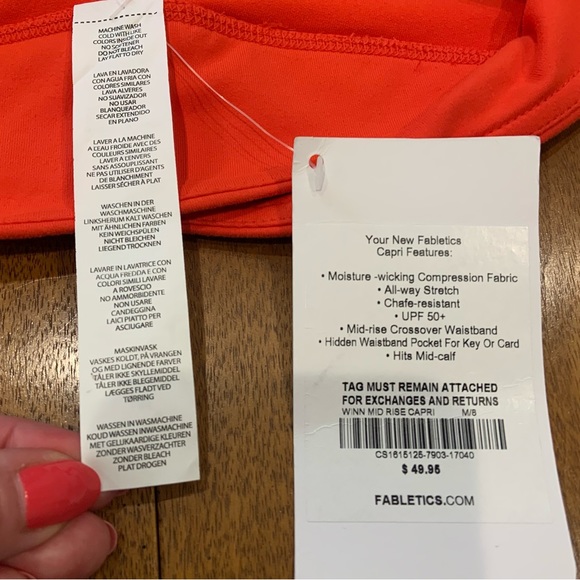Fabletics Midrise Capris in orange with crossover waistband and hidden pocket - Picture 5 of 8
